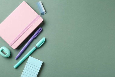 Kalemler ve yeşil arka plandaki diğer kırtasiyeler düz. Metin için boşluk