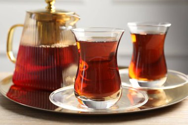 Ahşap masada servis edilen lezzetli Türk çayı, yakın plan.