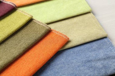 Açık ahşap masadaki farklı kumaşlardan örnekler.