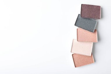 Beautiful eye shadow refill pans on white background, flat lay. Space for text