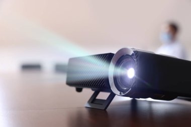 Modern video projektörü kapalı masa üzerinde, seçici odaklanma. Resim gösteriliyor