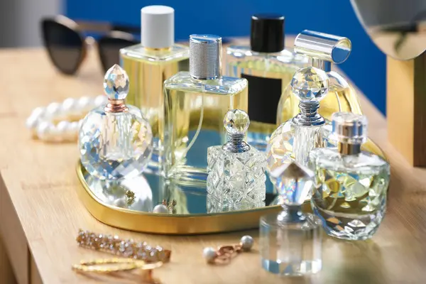 İçerideki ahşap masada parfüm şişeleri.