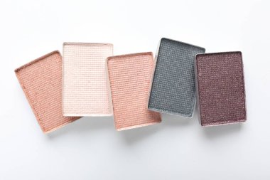 Beautiful eye shadow refill pans on white background, flat lay