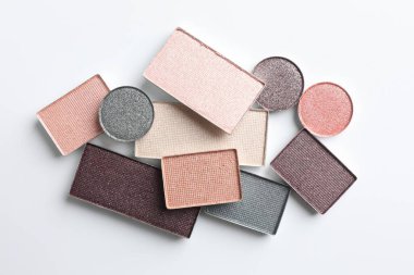 Beautiful eye shadow refill pans on white background, flat lay