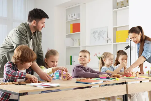 Çocuklar içeride öğretmenlerden ders alıyorlar.