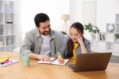 Babası kızına ev ödevlerinde yardım ediyor.