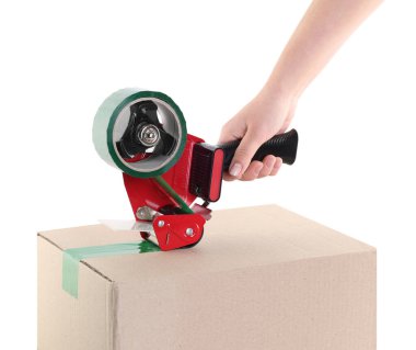 Kadın, beyaz arka plandaki karton kutuyu mühürlemek için yapışkan bantla yapıştırıcı kullanıyor.