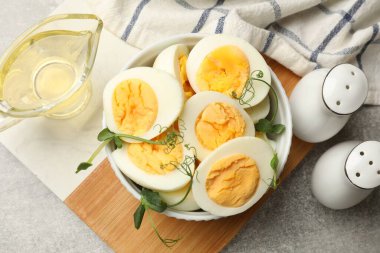 Haşlanmış yumurta ve mikroyeşiller gri masada, düz yerde.