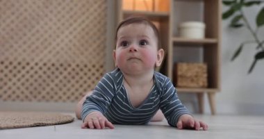 Evde yerde oynayan şirin bir bebek.