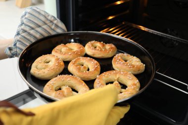 Fırından taze krakerlerle fırın yapan kadın, yakın plan.