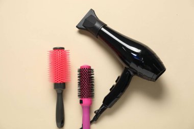 Bej arka planda yuvarlak fırçalar ve kurutma makinesi, düz konum