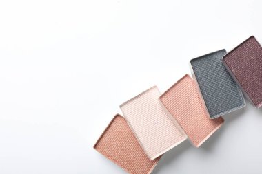 Beautiful eye shadow refill pans on white background, flat lay. Space for text