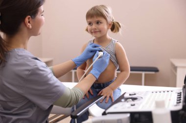 Sonograf klinikte küçük kızın kalbinin ultrason muayenesi yapıyor.