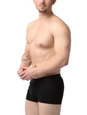 Beyaz arka planda siyah iç çamaşırlı genç adam, yakın plan.