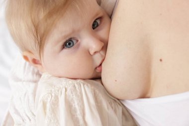 Anne küçük bebeğini emziriyor, yakın plan.