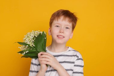 Sarı arka planda bir buket güzel çiçekli çocuk.