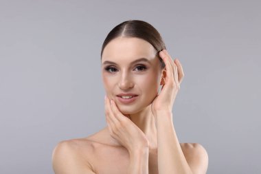 gri zemin üzerine güzel bir genç kadın portresi