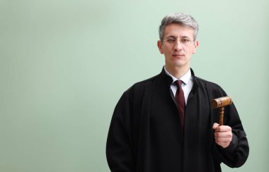 Yeşil arka planda çekiçli yargıç portresi. Metin için boşluk