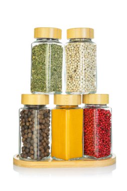 Beyaz kavanozlardaki farklı aromatik baharatlar.