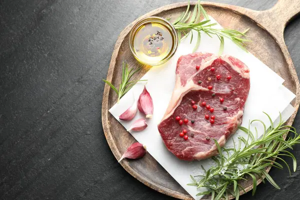 Siyah masanın üstünde çiğ et ve baharat var. Metin için boşluk