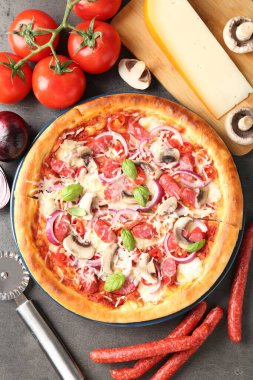 Lezzetli pizza füme sosis, malzemeler ve masanda makas.