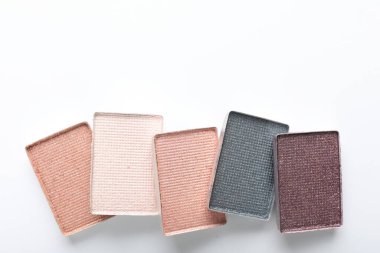 Beautiful eye shadow refill pans on white background, flat lay. Space for text