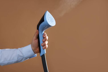 Kahverengi arka planda vapuru olan adam, yakın plan. Metin için boşluk