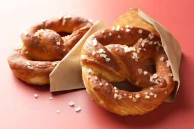 Kırmızı arkaplanda tuzlu krakerler, yakın plan.