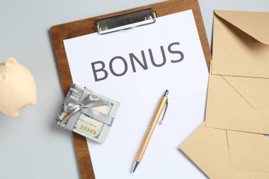 Kelime bonusu, zarf, para ve açık gri arka planda kumbara içeren pano, düz uzanma