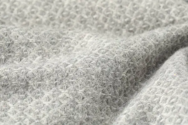 Arkaplan olarak açık gri yün kumaş dokusu, yakın plan