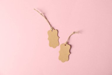 Pembe arka planda dizgileri olan boş etiketler, düz uzanma