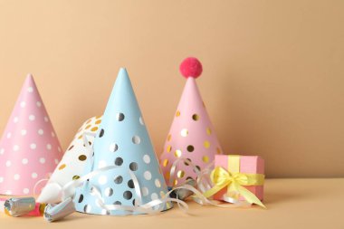 Parti şapkaları ve bej arka planda şenlik dekoru