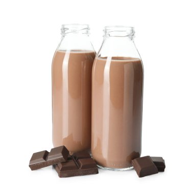 Cam şişelerdeki lezzetli çikolatalı süt ve beyaza izole edilmiş parçalar.