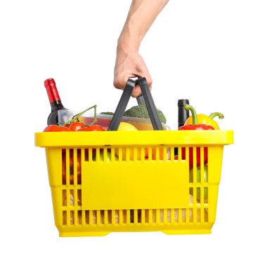 Beyaz arka planda farklı ürünleri olan alışveriş sepeti tutan adam, yakın plan.