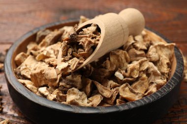 Kuru hindiba kökleri kasede ve ahşap masada kepçe, yakın plan.