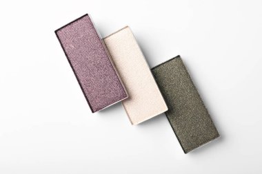 Beautiful eye shadow refill pans on white background, flat lay