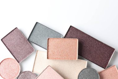 Beautiful eye shadow refill pans on white background, flat lay