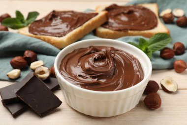 Fındıklı çikolata, fındık, tost, çikolata ve nane parçalarını ahşap masaya serer.