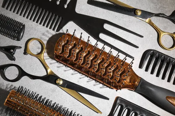 Gri masada farklı kuaförlerin aletleri var.