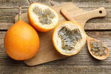 Olgun tutku meyveleri ve tohumlar ahşap masada, düz yatıyordu.