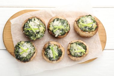 Beyaz ahşap masada servis edilen lezzetli mantarlar.