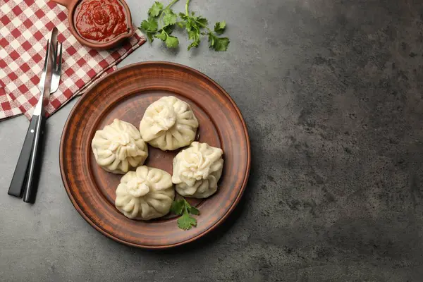 Gri masadaki sosla servis edilen lezzetli khinkali.