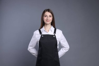 Gri arka planda neşeli baristanın portresi