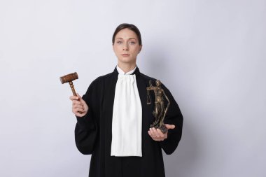 Hafif arkaplanda Adalet Anıtı figürü ve tokmakla yargıla