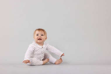 Açık gri arka planda şirin küçük bebek, metin için boşluk