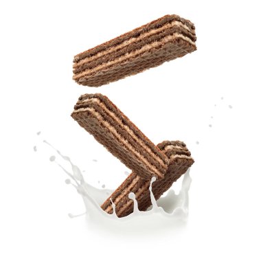 Lezzetli gevrek gofretler beyaz arka plana süt sıçratıyor.