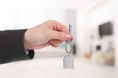 Emlakçı evin anahtarını tutuyor, yakın plan.