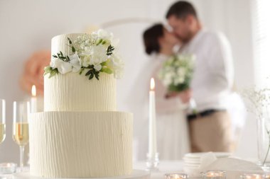 Mutlu evli çift içeride, masadaki düğün pastasına odaklan.