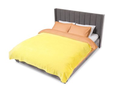 Beyaz arka planda güzel çarşaflarla yapılmış bir yatak.