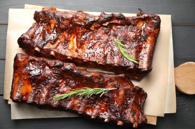 Siyah ahşap masada biberiyeli domuz pirzolası.